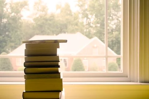 Stack of Books in Front of Window Foto stock