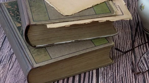 Stack of books with glasses and cup of tea. Stock Footage 165931687