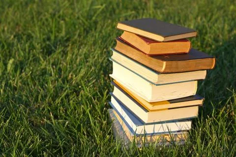 Stack of books in the grass Stock Photos