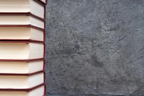 Stack of books on the gray concrete background. Back to school. Education. Co Stock Photos