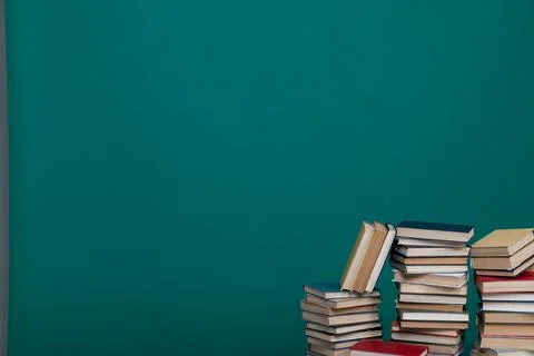 Stack of books on a green background in the learning library Stock Photos