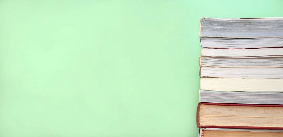 Stack of books on green background. Stock Photos