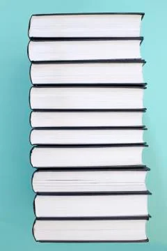 A stack of books on a green background, side view Foto stock