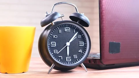 Stack of books , laptop and clock on table close up Video stock 147861228