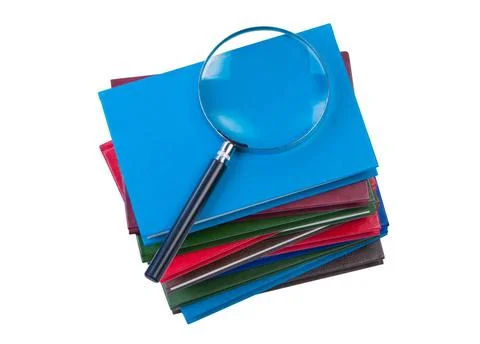 Stack of books with magnifying glass isolate on white background. Stack of... Foto stock