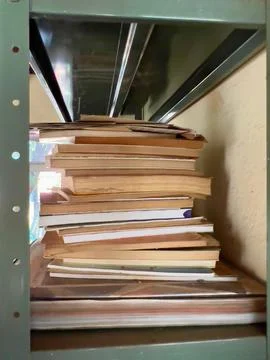 Stack of books on a metal shelf Stock Photos