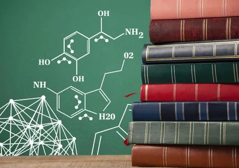 Stack of books next to blackboard with science diagrams 写真素材