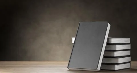 Stack of books, notepads on a wooden background. 3D rendering. イラスト素材