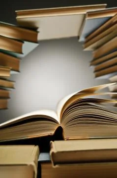 Stack Of Books With One Opened Among Them Stock Photos