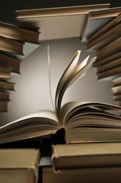 Stack Of Books With One Opened Among Them Stock Photos