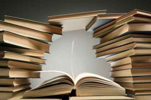 Stack Of Books With One Opened Among Them Stock Photos