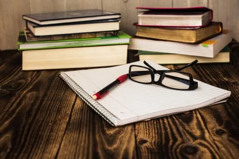 Stack of books, pecil, notebook, glasses, study Stock Photos
