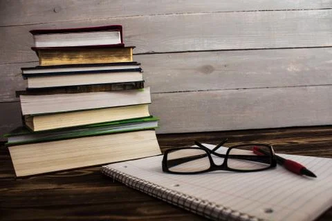 Stack of books, pecil, notebook, glasses, study Stock Photos
