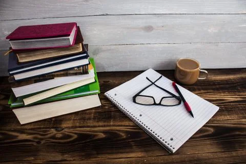 Stack of books, pecil, notebook, glasses, coffee Stock Photos