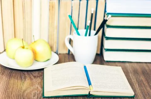Stack of books, pencils, open book, glasses, background for education learnin Stock Photos