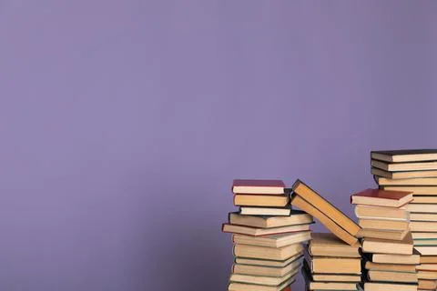 A stack of books on a purple background in the library in the office Stock Photos