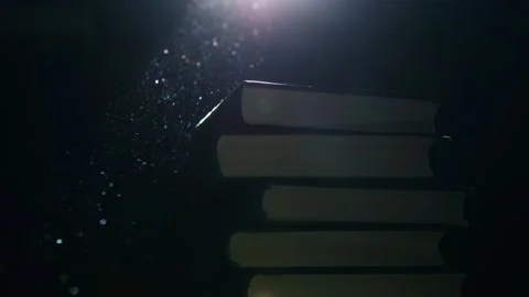 Stack of books in a ray of light Stock Footage 258838514