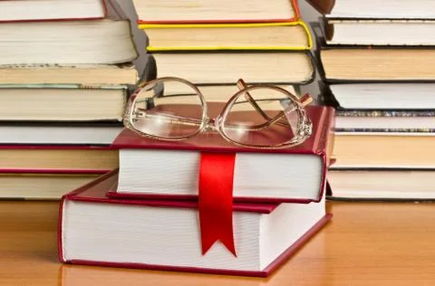 A stack of books with a red ribbon Stock Photos