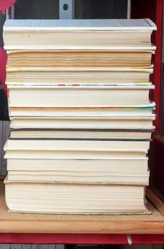 Stack of books on a shelf in a book store, selective focus Stock Photos