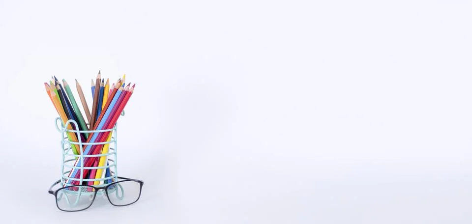 A stack of books, study guides, textbooks, glasses, and pencils in a text cop Stock Photos