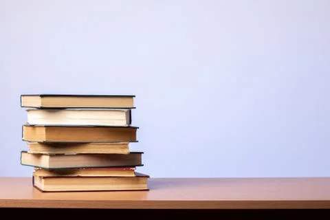 Stack of books on the table on a blue background. learning concept. literature. Stock Photos