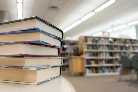 Stack of books on table at library Foto stock
