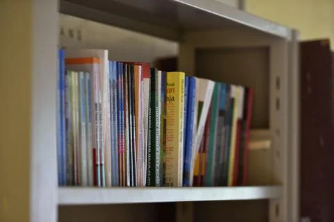Stack of books on table at library Foto stock