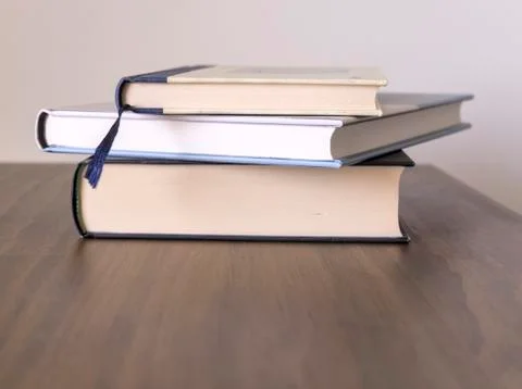 Stack of books on a table with light colored background.Education learning an Stock Photos