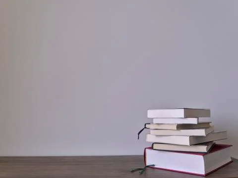 Stack of books on a table with light colored background.Education learning an Stock Photos