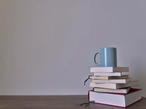 Stack of books on a table with light colored background.Education learning an Stock Photos