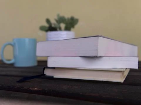 Stack of books on a table with light colored background.Education learning an Stock Photos