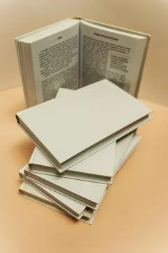 A stack of books on the table on a light pink background, study, back to scho 写真素材