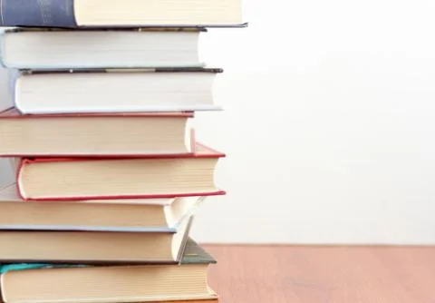 A stack of books on a table or on a shelf in a bookstore or library.Concept o Stock Photos