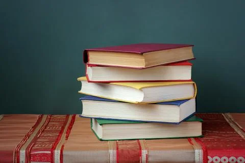 A stack of books on the table with a red tablecloth. Foto stock