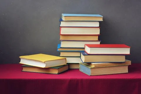 A stack of books on the table with a red tablecloth. Foto stock