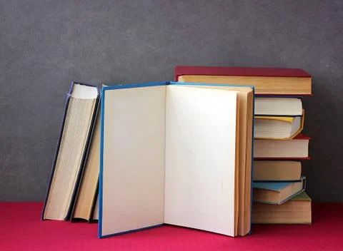 Stack of books on the table with a red tablecloth. Foto stock