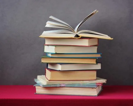 Stack of books on the table with a red tablecloth. Stock-Fotos