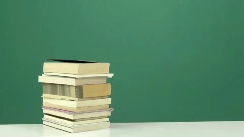 Stack of Books on White Table with Chroma Key Green Screen Background Video stock 344677987