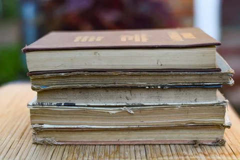 Stack of books on a wood table and green bokeh Stock Photos