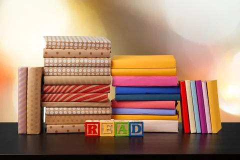 Stack of books on wooden table against blurred background 스톡 사진