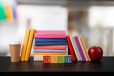 Stack of books on wooden table against blurred background 写真素材