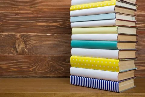 Stack of books on wooden table. Back to school. Copy space Photos