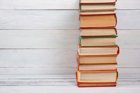 Stack of books on wooden table. Back to school. Copy space Photos