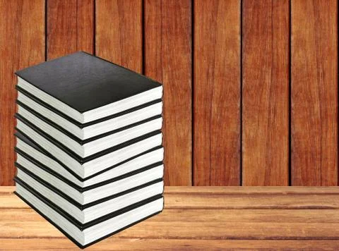 Stack of books on wooden table over wooden background Stock-Fotos