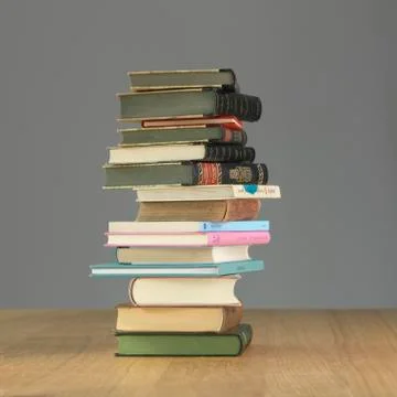 A stack of books on a wooden table 스톡 사진