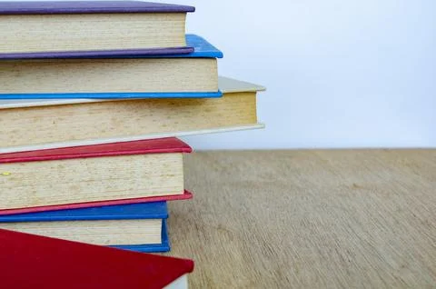 Stack of books on wooden table representing study and knowledge, with custo.. Fotos de archivo