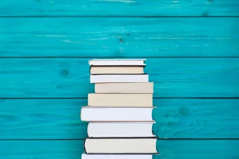 Stack of books on wooden turquoise background. Free place for text. Education Stock Photos