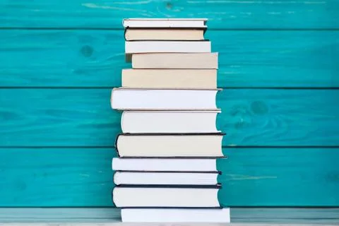 Stack of books on wooden turquoise background.  Education concept Stock Photos