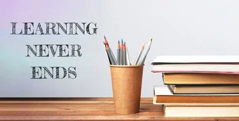 Stack of books with the words learning never ends Stock Photos