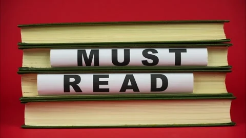 Stack of Books with the words “MUST READ”. Must Read Concept. Stop motion Видео 326069931